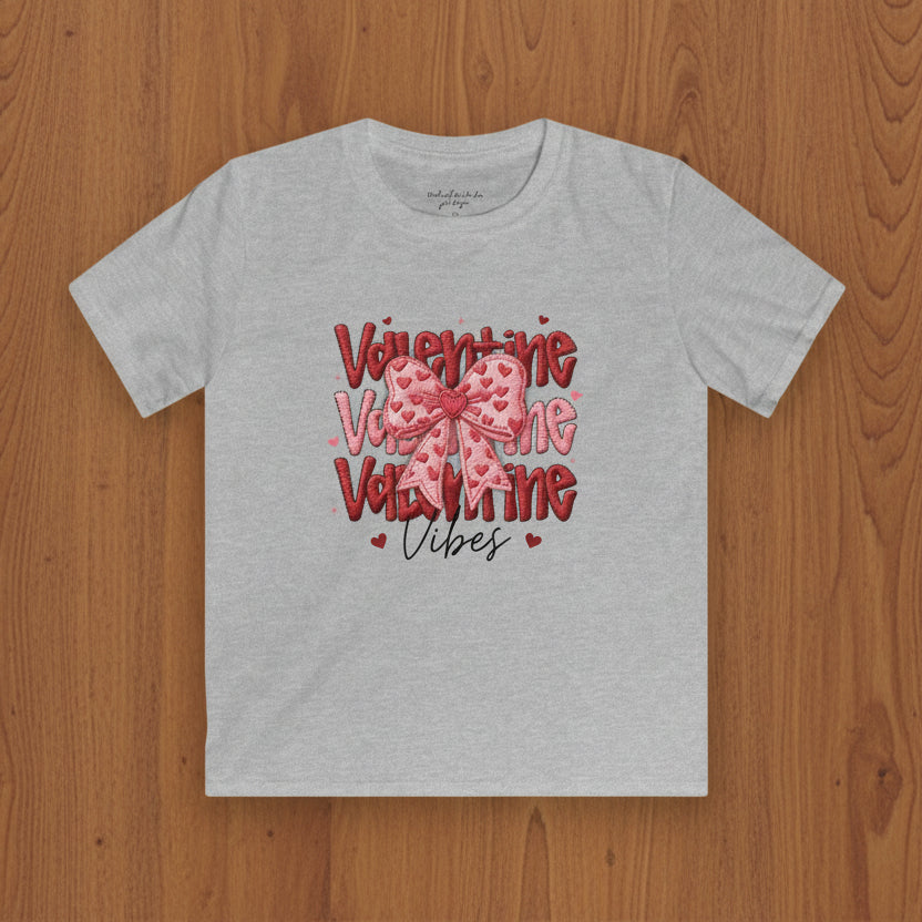 Gray t-shirt with Valentine's Day design featuring a bow and text on a wood background