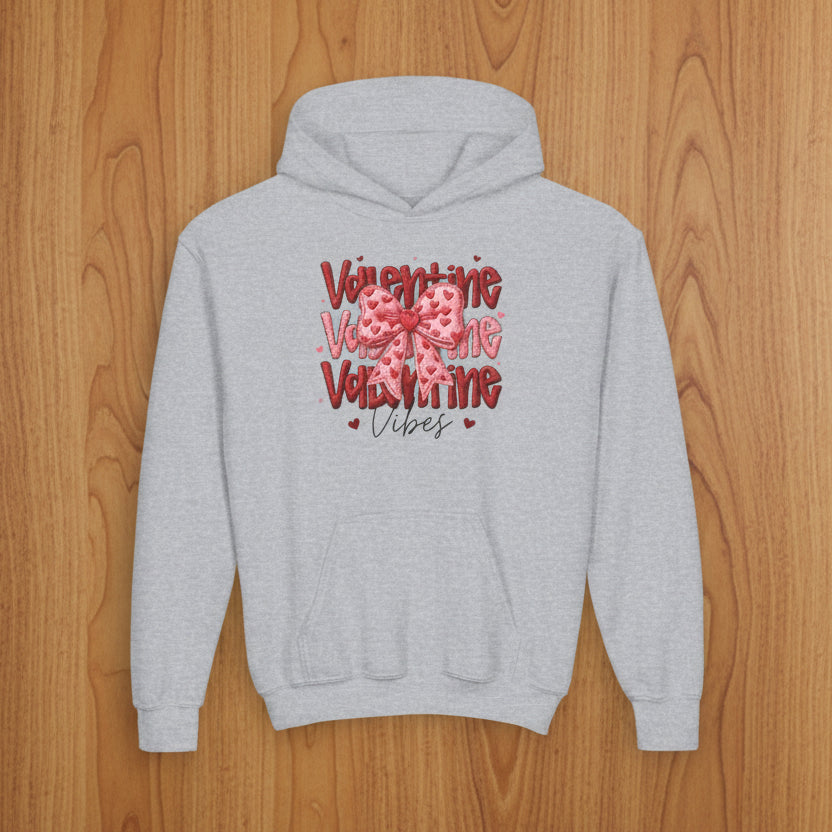 Gray hoodie with Valentine's Day design on a wood background