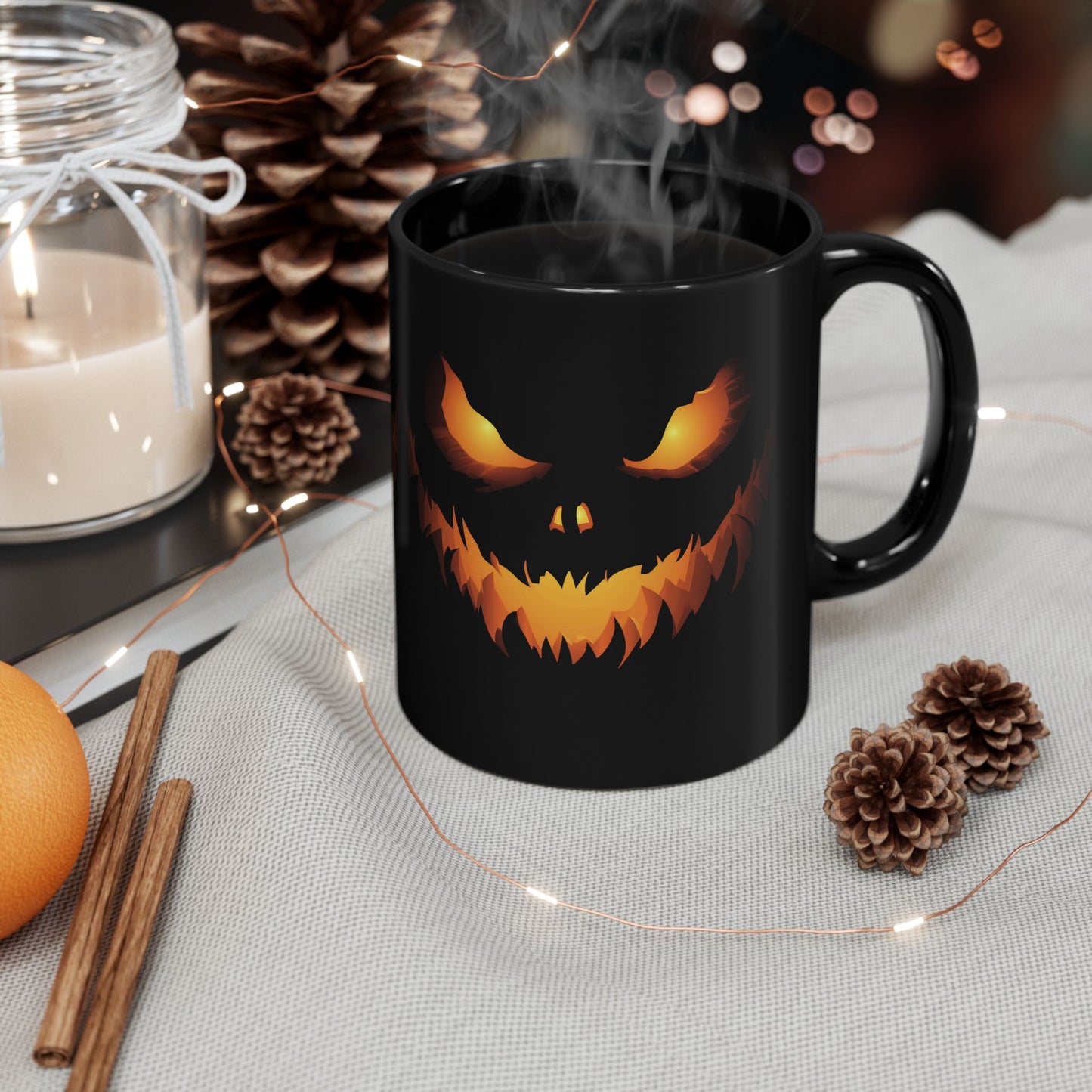 Black mug with glowing jack o' lantern face