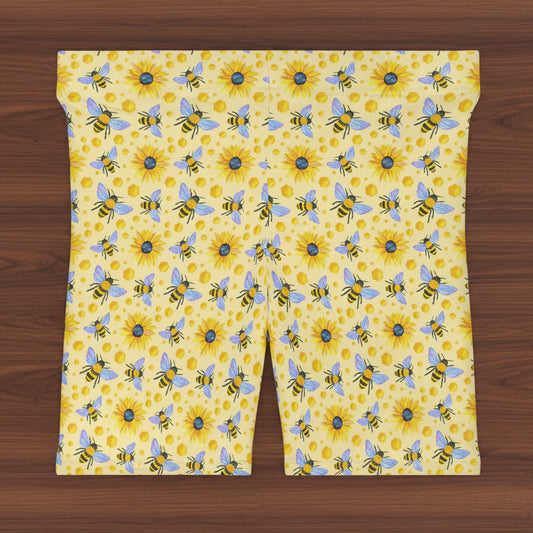 Patterned fabric with bees and sunflowers on a yellow background